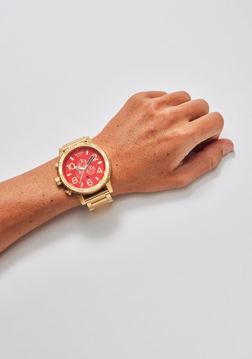 red and gold nixon watch